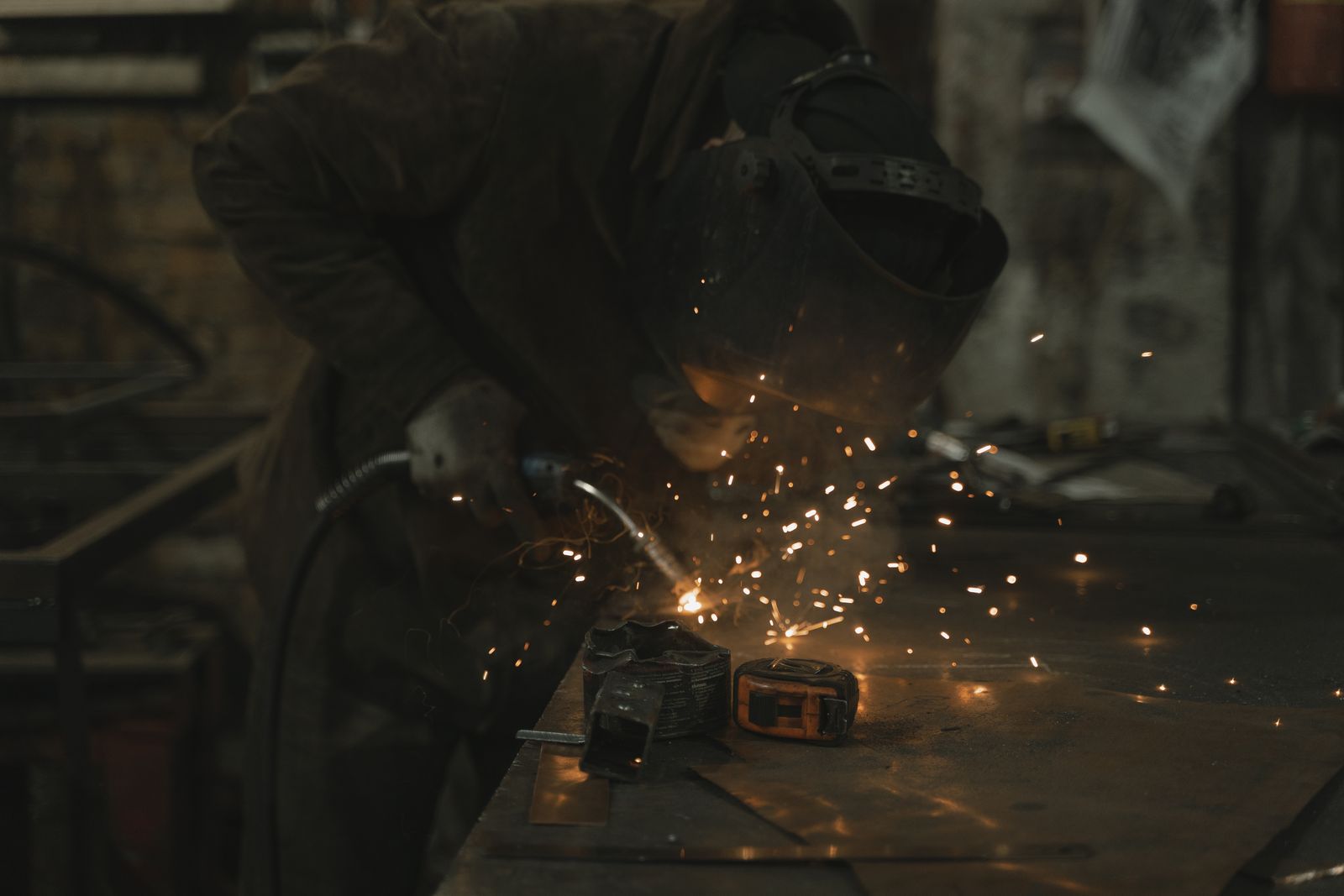Welder working with sparks in an industrial shop